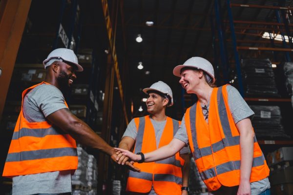 Diverse Warehouse Workers High-five
